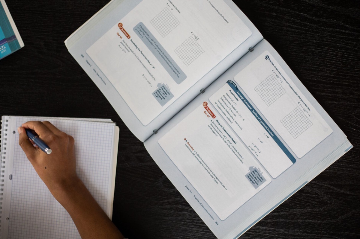 Student using textbook for math education in K-12 classroom