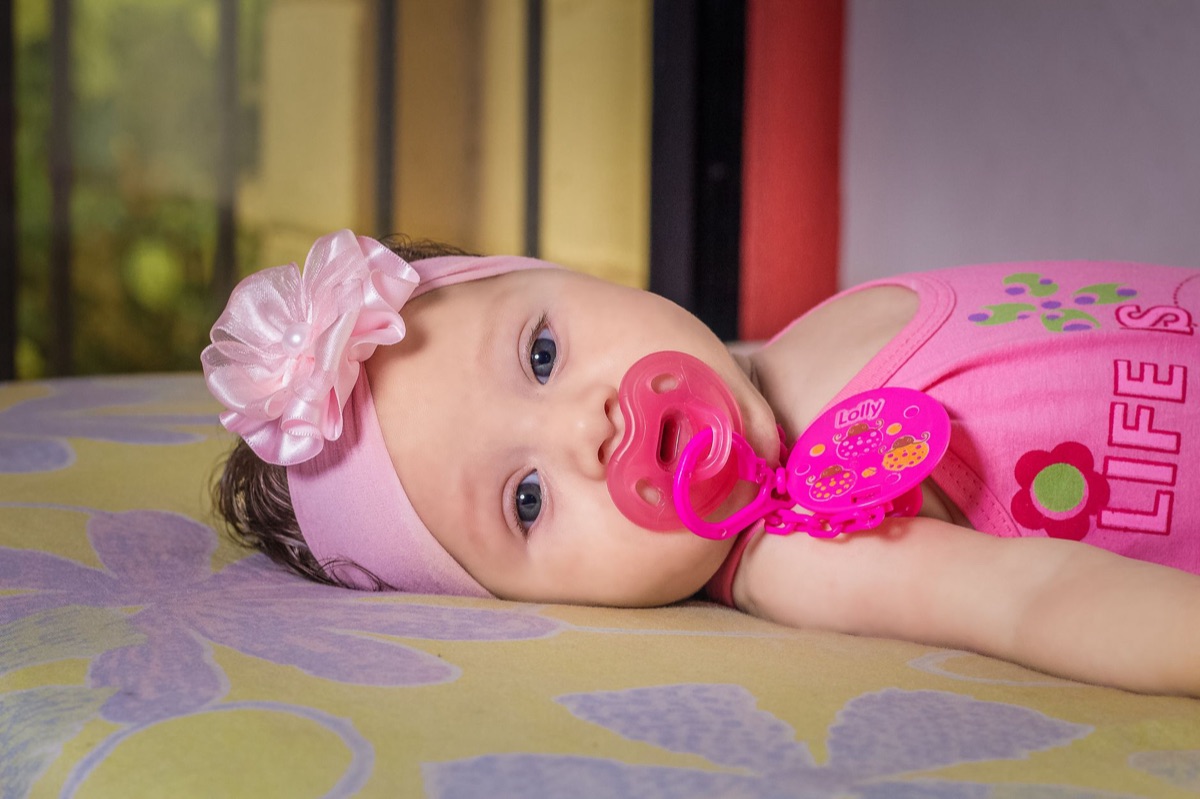 baby with pacifier in crib