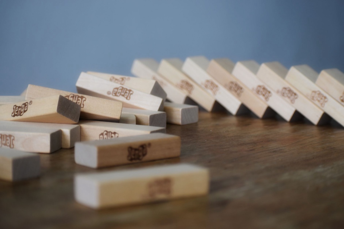 A pile of colorful wooden building blocks on a bright floor.